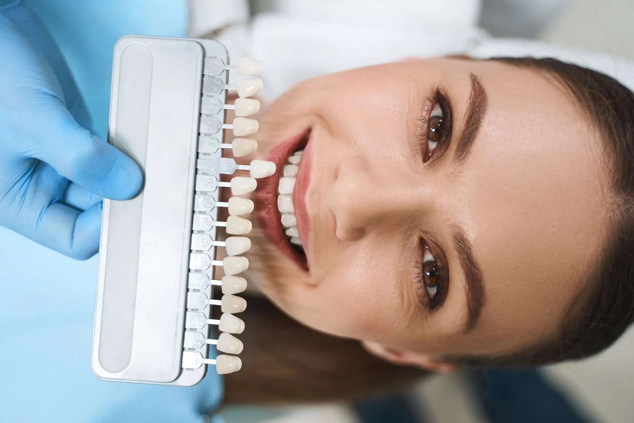Smiling woman is choosing veneers stock photo